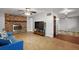 Spacious living room with brick fireplace, ceiling fan, and wood-look flooring at 33311 Green Rd, Leesburg, FL 34788