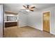 Bright main bedroom with ensuite bathroom access, ceiling fan, and parquet-patterned floors at 33311 Green Rd, Leesburg, FL 34788