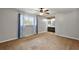 Bright main bedroom with ensuite bathroom access, ceiling fan, and parquet-patterned floors at 33311 Green Rd, Leesburg, FL 34788