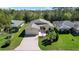 An aerial view showcasing this home's spacious lawn, well-kept landscaping, and prime corner lot location at 341 Ranchwood Dr, Leesburg, FL 34748
