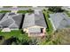 Aerial view of home featuring a screened-in patio and a well-manicured lawn at 341 Ranchwood Dr, Leesburg, FL 34748