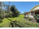 Expansive lawn featuring verdant grass, mature trees, and landscaped borders at 341 Ranchwood Dr, Leesburg, FL 34748