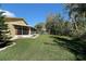 Wide backyard space with healthy lawn, mature trees, and property perimeter at 341 Ranchwood Dr, Leesburg, FL 34748