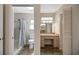 Bright bathroom featuring a shower and vanity with sink, mirror, and plentiful cabinet space at 341 Ranchwood Dr, Leesburg, FL 34748