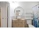 Bathroom boasts round mirror, vessel sink, and tiled backsplash at 341 Ranchwood Dr, Leesburg, FL 34748