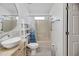 Bathroom features round mirror, vessel sink, and combined tub shower at 341 Ranchwood Dr, Leesburg, FL 34748