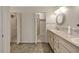 Bright bathroom featuring a sink vanity with plentiful counter space and cabinet storage, and an open closet at 341 Ranchwood Dr, Leesburg, FL 34748