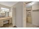 Spacious bathroom featuring a vanity with sink, mirror, and cabinet storage, plus bi-fold closet doors at 341 Ranchwood Dr, Leesburg, FL 34748