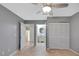 Bedroom features tiled floors, ceiling fan, closet, and access to ensuite bath at 341 Ranchwood Dr, Leesburg, FL 34748