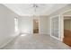 Neutral bedroom with tile flooring, ceiling fan, and natural light at 341 Ranchwood Dr, Leesburg, FL 34748