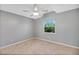Bedroom featuring a ceiling fan and a window with green outdoor views that add a peaceful element at 341 Ranchwood Dr, Leesburg, FL 34748