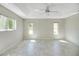 Bright bedroom with natural light, tiled floor, and modern ceiling fan at 341 Ranchwood Dr, Leesburg, FL 34748