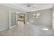 Bright bedroom with a ceiling fan and doors opening to a screened patio, and a large window at 341 Ranchwood Dr, Leesburg, FL 34748