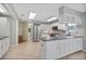 Well-lit kitchen with stainless steel appliances, custom cabinetry, and tile floors at 341 Ranchwood Dr, Leesburg, FL 34748