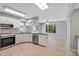 Spacious kitchen features stainless steel appliances, tile floors, and ample counter space at 341 Ranchwood Dr, Leesburg, FL 34748