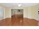 Open-concept living room with wood floors and vaulted ceiling at 341 Ranchwood Dr, Leesburg, FL 34748