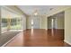 Open living room with wood floors, ceiling fan, and sunroom at 341 Ranchwood Dr, Leesburg, FL 34748