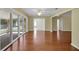 Bright living room has wood floors, ceiling fan, and access to the sunroom at 341 Ranchwood Dr, Leesburg, FL 34748