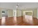 Spacious living room featuring beautiful hard wood floors, neutral paint and multiple ceiling fans at 341 Ranchwood Dr, Leesburg, FL 34748
