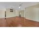 Spacious living room features hardwood floors, neutral paint, ceiling fans, and an open floor plan at 341 Ranchwood Dr, Leesburg, FL 34748