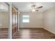 Bright, spacious main bedroom with hard wood floors, window and large wardrobe at 341 Ranchwood Dr, Leesburg, FL 34748