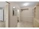 Walk-in closet featuring ample storage space with mirrored door and built-in shelving and clothes rods at 341 Ranchwood Dr, Leesburg, FL 34748