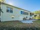 Exterior view of home with back patio, blue sky and landscaping at 351 Groveland Rd, Mount Dora, FL 32757