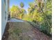 Well-maintained backyard with lush landscaping, stone patio, and convenient grill area at 351 Groveland Rd, Mount Dora, FL 32757