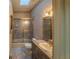 Bathroom with tile floors, framed shower, and gold light fixtures at 351 Groveland Rd, Mount Dora, FL 32757