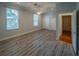 Bedroom with wood laminate flooring, natural light, with closets on either side of a door at 351 Groveland Rd, Mount Dora, FL 32757