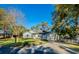 Inviting single-story home featuring a lush front lawn, mature trees, and a welcoming driveway at 351 Groveland Rd, Mount Dora, FL 32757