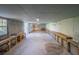 Well-lit garage with concrete flooring, multiple windows, and built-in workbenches and shelving at 351 Groveland Rd, Mount Dora, FL 32757