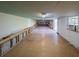 Bright garage features a window AC unit, built-in shelving, and concrete flooring with parquet flooring at 351 Groveland Rd, Mount Dora, FL 32757