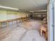 Bright, well-lit garage space with concrete flooring, built-in shelving, and convenient workbenches at 351 Groveland Rd, Mount Dora, FL 32757