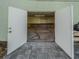 Large garage with a stone floor entrance and lots of lighting with custom built in workbenches for storage at 351 Groveland Rd, Mount Dora, FL 32757