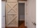 Hallway featuring a decorative sliding barn door at 351 Groveland Rd, Mount Dora, FL 32757