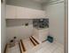 Bright laundry room with overhead cabinets and neutral tile floors at 351 Groveland Rd, Mount Dora, FL 32757