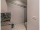 Well-lit laundry room with tile floors and mosaic backsplash at 351 Groveland Rd, Mount Dora, FL 32757
