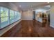 Open living space with hardwood floors that flows into a kitchen with stainless steel appliances and granite countertops at 351 Groveland Rd, Mount Dora, FL 32757