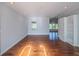 Bright living room with hardwood floors, built-in shelving, and plenty of natural light at 351 Groveland Rd, Mount Dora, FL 32757
