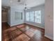 Well-lit room with ceiling fan, hardwood floors, and a large window with blinds at 351 Groveland Rd, Mount Dora, FL 32757