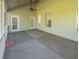 Covered back porch with stained wood decking and ceiling fan at 351 Groveland Rd, Mount Dora, FL 32757