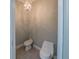 Toilet room with tile floors, a toilet, bidet, and a decorative chandelier at 351 Groveland Rd, Mount Dora, FL 32757