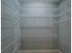 Walk-in closet with white wire shelving for optimal storage and organization at 351 Groveland Rd, Mount Dora, FL 32757