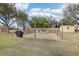 An inviting backyard area showcasing a cozy fire pit area and mature trees at 3909 Cr 532A, Bushnell, FL 33513