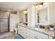 Modern bathroom featuring double vanity, granite countertop, and walk-in shower at 3909 Cr 532A, Bushnell, FL 33513