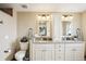 Bright bathroom featuring a double vanity with granite countertop and modern lighting fixtures at 3909 Cr 532A, Bushnell, FL 33513