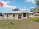 Charming home with a metal roof, arched windows, and a well-manicured lawn adding to its curb appeal at 3909 Cr 532A, Bushnell, FL 33513