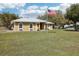 Attractive home with an American flag, well-manicured lawn, and stone accents at 3909 Cr 532A, Bushnell, FL 33513