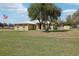 Charming home with stone accents, a well-maintained lawn, and mature tree in the front yard at 3909 Cr 532A, Bushnell, FL 33513